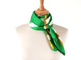 a mannequin with a green and white scarf on it