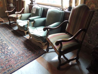 trois chaises et un canapé dans une pièce avec un tapis