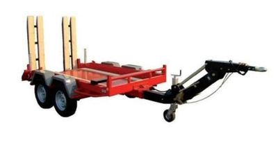 a red trailer with two wooden poles attached to it