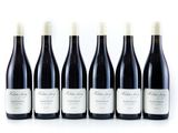 six bottles of red wine lined up in a row