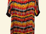 an orange, yellow and black striped dress on a mannequin mannequin mannequin mannequin mannequin mannequin mannequin mann