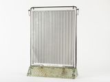 a metal radiator that is sitting on a stand