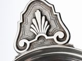 a silver plate with a decorative design on top of it