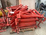 a pile of red wooden pallets sitting on the ground