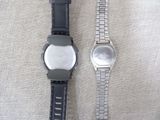 two watches sitting next to each other on a table