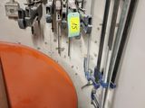 several buckets of paint are lined up against a wall