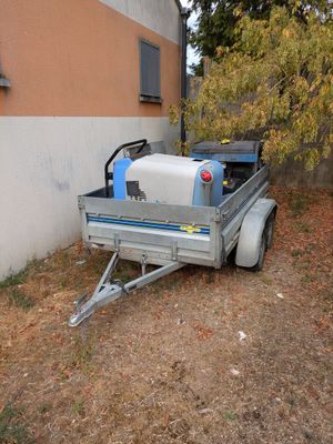 a small trailer with a water tank in the back of it