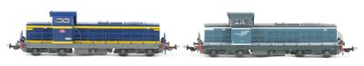 two toy trains sitting side by side on a white surface
