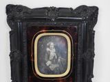 a picture of a woman sitting in a chair in a picture frame