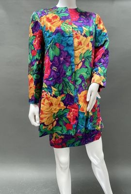 a mannequin wearing a multicolored dress with flowers on it