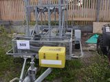 a small trailer with a yellow box attached to it