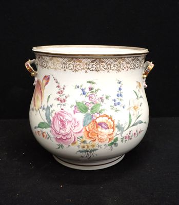 a vase with flowers painted on it on a black surface