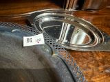 a silver plate with a spoon on it on a table