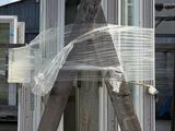 a large wooden structure that is wrapped in plastic