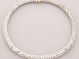 a silver and gold necklace with a clasp on a white background
