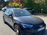 a black audi is parked on the side of the road