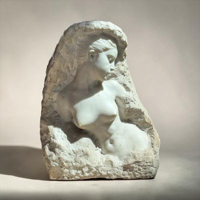 marble sculpture of a woman ' s head on a rock