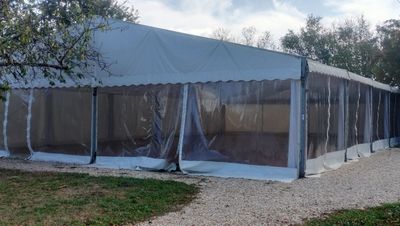 a large tent that is set up in the grass