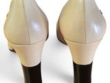 the back of a pair of women ' s shoes on a white surface