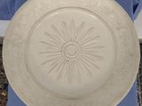 a white plate that has a flower design on it