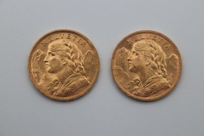 two gold sovereigns, one of which is a woman and one of which is a man