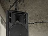 a speaker hanging from the ceiling of a building