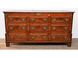 an antique oak chest of drawers with brass handles