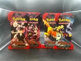 two packs of pokemon trading cards sitting on top of a couch