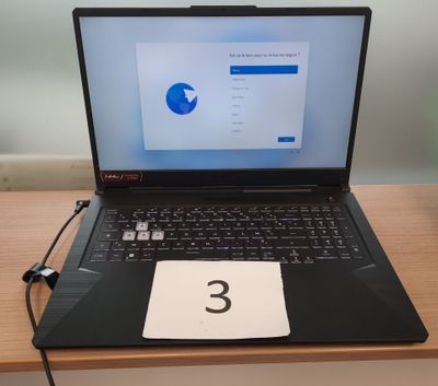 a laptop computer sitting on top of a wooden desk