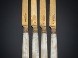 three knives and a knife holder on a black background