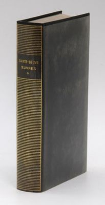 an old book sitting on top of a table next to a white background