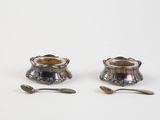 pair of silverplated candlesticks with spoons and spoon rest