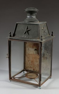 an old metal lantern with a star on the top of it