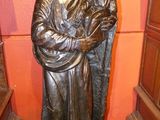 bronze statue of a woman holding a child in her arms