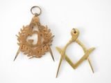 two masonic symbols are shown on a white surface