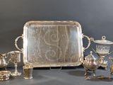 a silver tray with a silver tray and other silver items