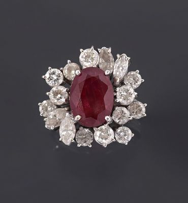 an oval ruby and diamond cluster ring