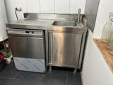 a stainless steel sink and a dishwasher in a kitchen