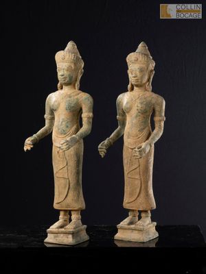 two statues of a man and a woman standing next to each other