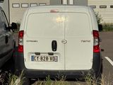 two vans parked in a parking lot next to each other