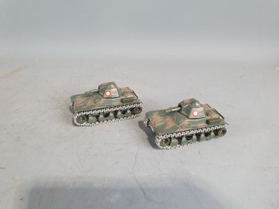two toy tanks that are sitting on a table