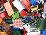 a large pile of toy cars and trucks in a pile