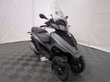 a motorcycle that is parked on a checkered floor