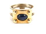 an image of a gold ring with a blue stone