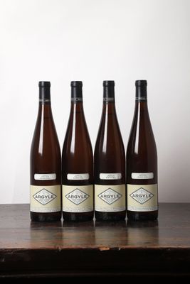 six bouteilles de vin sont alignées sur une table