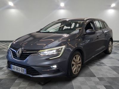 a grey car is parked on a checkered floor in a garage