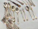 a lot of silver spoons and forks on the table