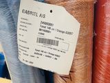 many rolls of fabric that are on display in a store