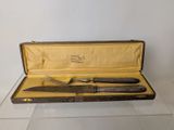 a knife and a fork in a case on a table