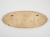 a close up of a wooden plaque on a white surface